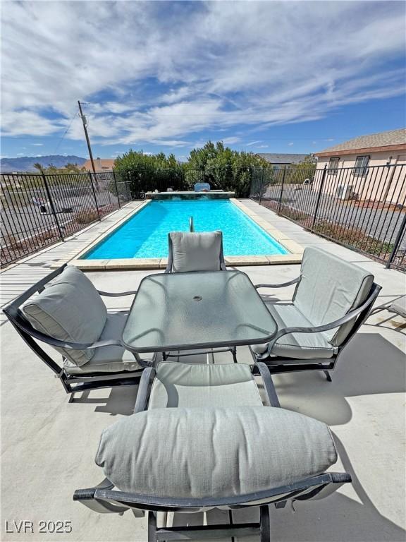 view of swimming pool with a patio, fence, and a fenced in pool