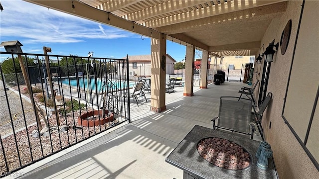 view of patio / terrace with fence, a community pool, and a pergola