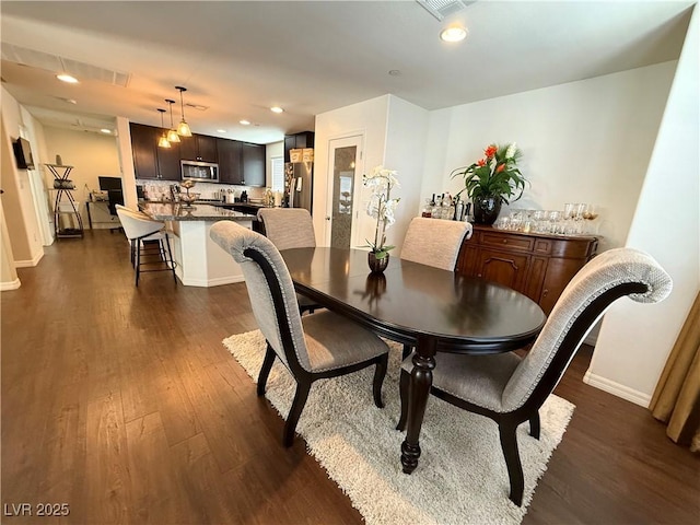 dining room featuring recessed lighting, dark wood-style flooring, visible vents, and baseboards