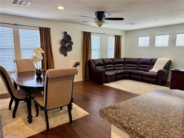 interior space featuring baseboards, visible vents, ceiling fan, dark wood-style flooring, and recessed lighting