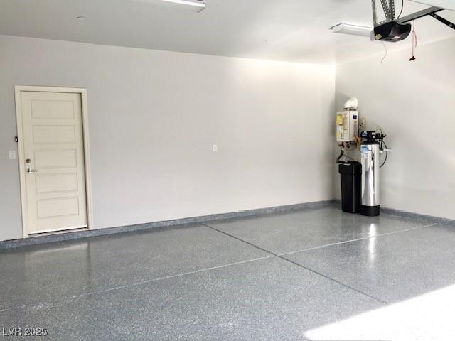 garage featuring a garage door opener and baseboards