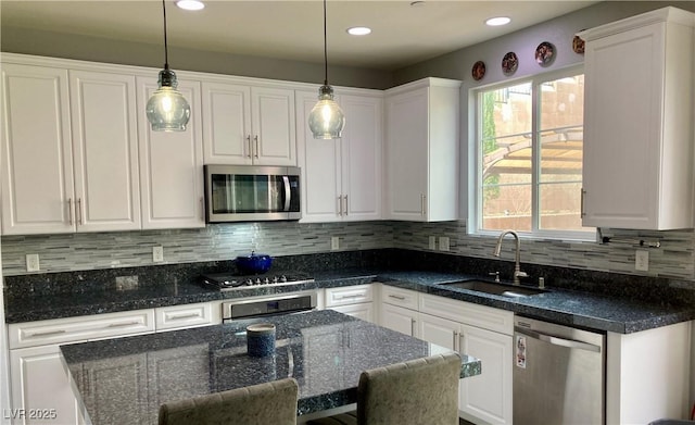 kitchen with white cabinets, appliances with stainless steel finishes, and a sink