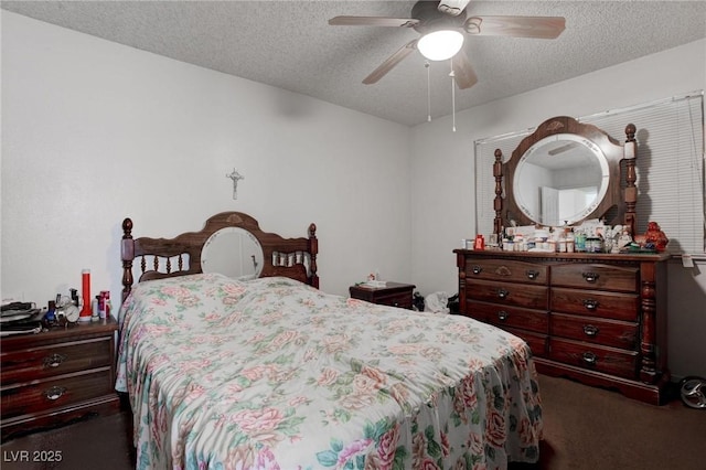 carpeted bedroom featuring a ceiling fan and a textured ceiling