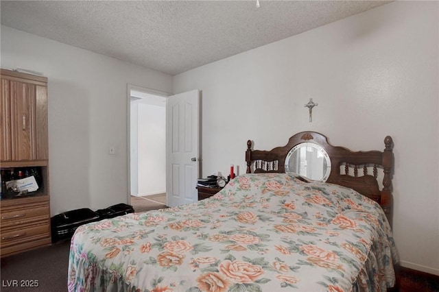 carpeted bedroom featuring a textured ceiling