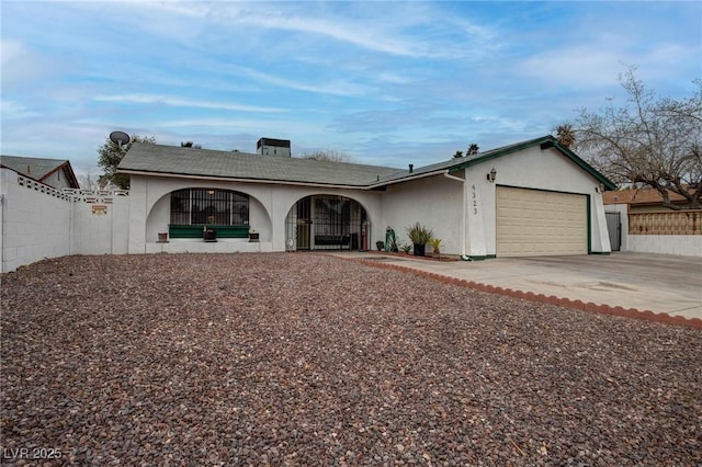 single story home featuring fence, driveway, an attached garage, and stucco siding