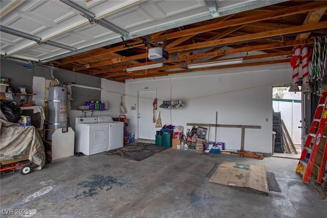 garage featuring water heater, washer and dryer, and a garage door opener