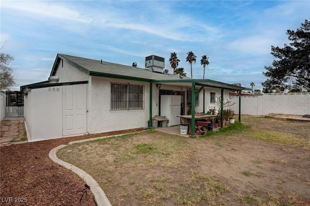 back of house featuring fence, a patio, and stucco siding