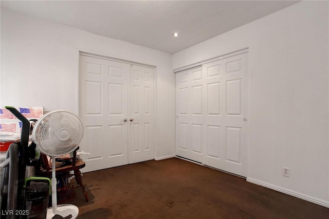 interior space with recessed lighting, dark carpet, and baseboards