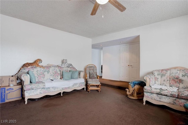 sitting room with carpet floors, a textured ceiling, and a ceiling fan