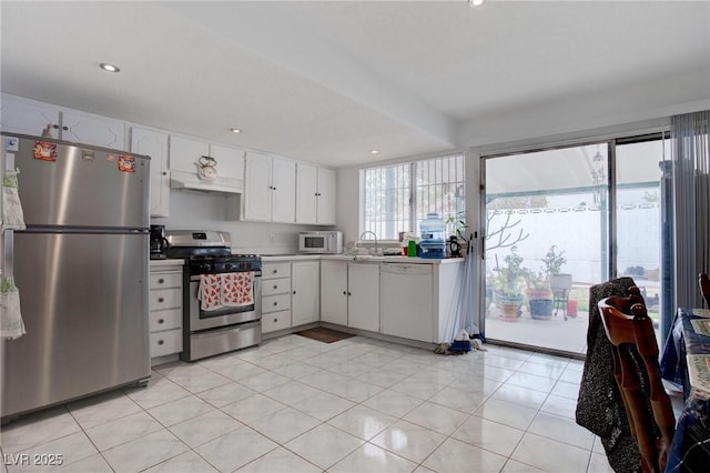 kitchen with recessed lighting, light countertops, appliances with stainless steel finishes, white cabinets, and a sink