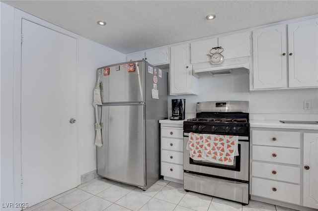 kitchen with light tile patterned floors, light countertops, appliances with stainless steel finishes, and white cabinetry