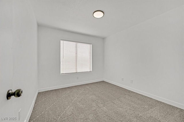 carpeted empty room with baseboards