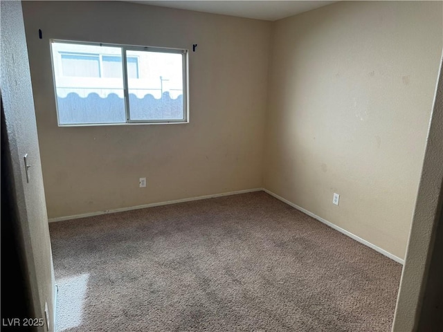 unfurnished room with carpet floors and baseboards