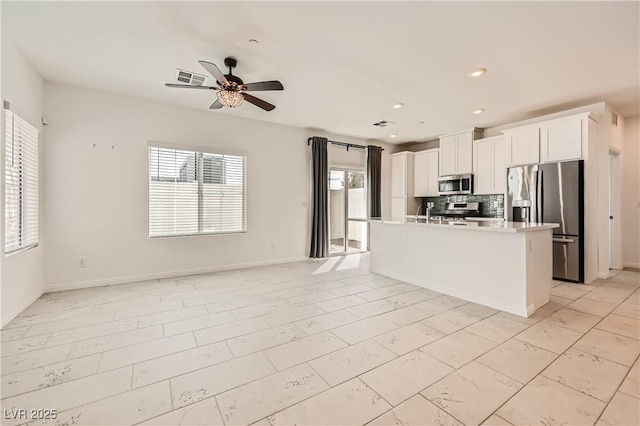 kitchen with appliances with stainless steel finishes, visible vents, and a healthy amount of sunlight