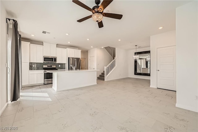 kitchen with visible vents, white cabinets, stainless steel appliances, backsplash, and recessed lighting