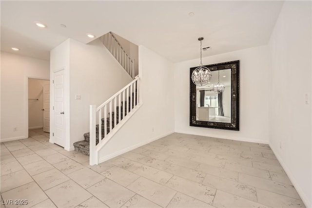 interior space with visible vents, baseboards, a notable chandelier, and recessed lighting