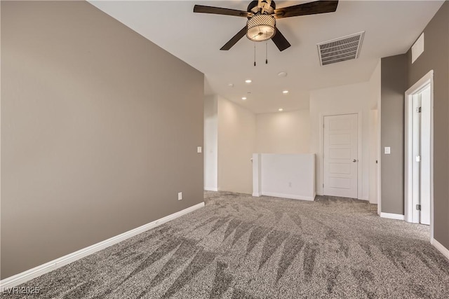 carpeted empty room featuring a ceiling fan, recessed lighting, visible vents, and baseboards