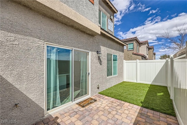 exterior space with a patio area and a fenced backyard