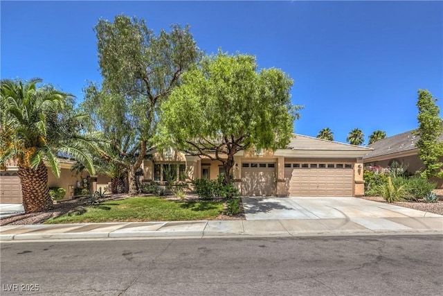 view of front facade featuring stucco siding, driveway, and a garage