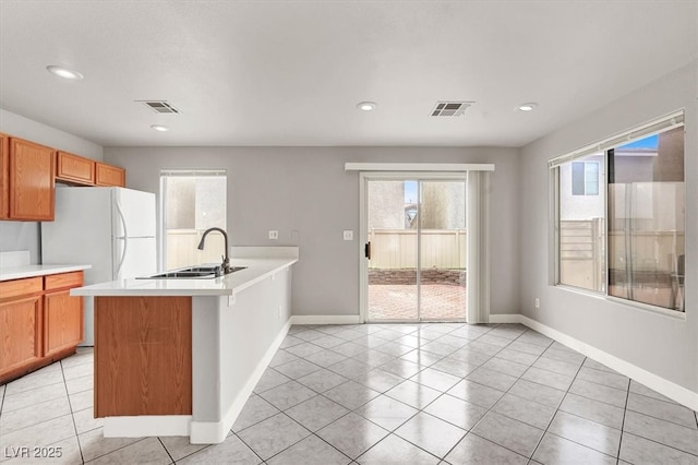 kitchen featuring light countertops, visible vents, and a sink