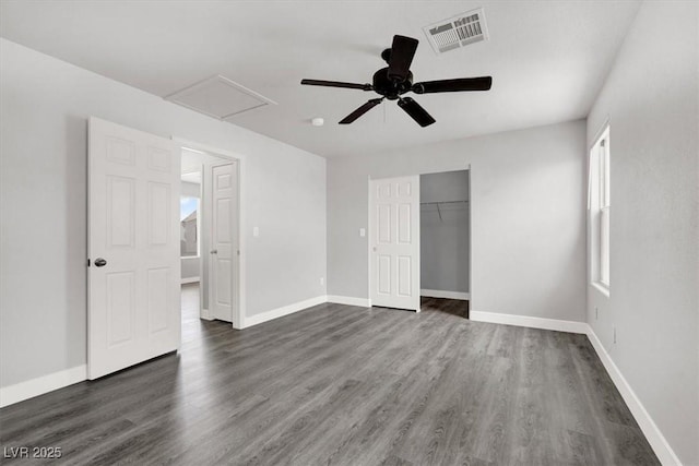 unfurnished bedroom featuring baseboards, visible vents, a ceiling fan, dark wood-type flooring, and a closet