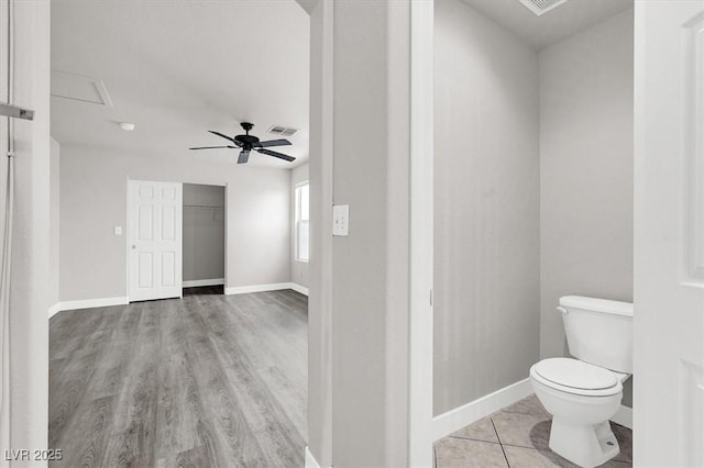 bathroom featuring baseboards, visible vents, a ceiling fan, toilet, and tile patterned floors