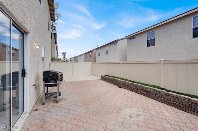 view of patio featuring a fenced backyard and a grill