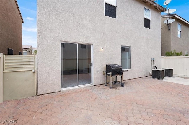 rear view of property with a patio and stucco siding