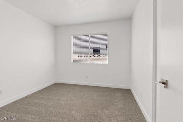 carpeted empty room with baseboards