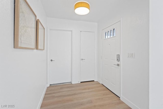 interior space with baseboards and light wood-style floors