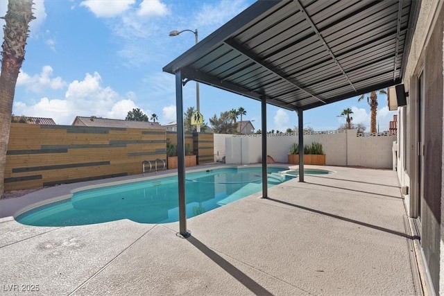 view of pool with a patio, a fenced backyard, and a pool with connected hot tub