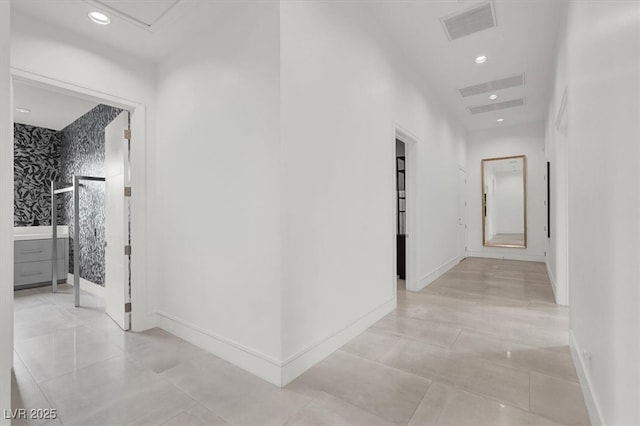 corridor featuring baseboards, visible vents, and recessed lighting