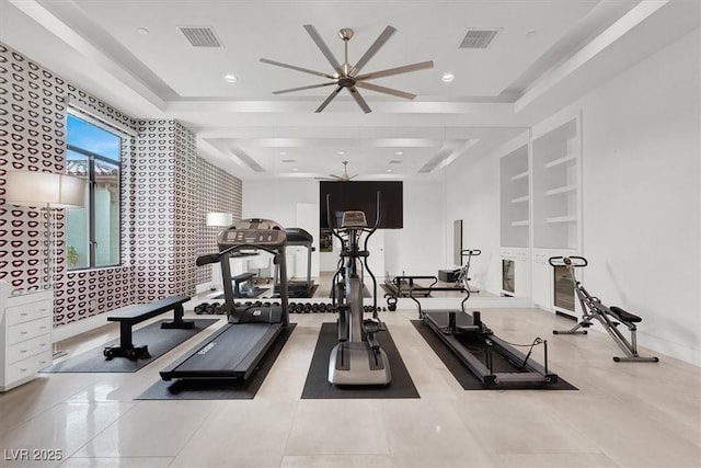 workout area featuring recessed lighting, a raised ceiling, and visible vents