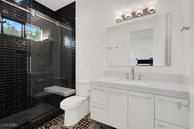 full bath featuring toilet, a shower stall, and vanity