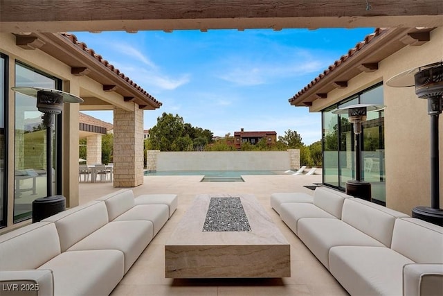 view of patio / terrace with an outdoor living space with a fire pit