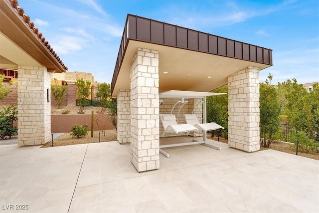 view of patio featuring fence