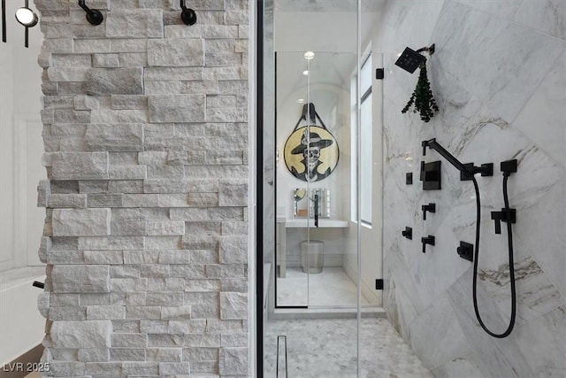 full bath with a marble finish shower