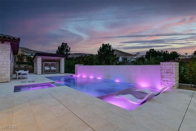 view of pool featuring a patio area and a pool with connected hot tub