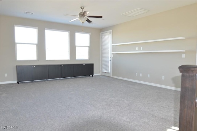 unfurnished room featuring carpet, visible vents, and baseboards