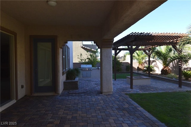 view of patio / terrace with area for grilling and a pergola