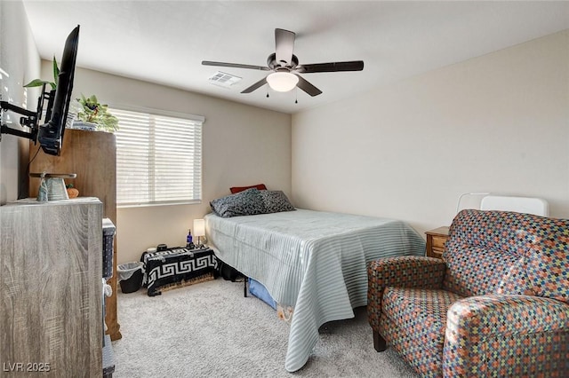 carpeted bedroom with visible vents and a ceiling fan