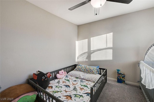 carpeted bedroom with baseboards and a ceiling fan