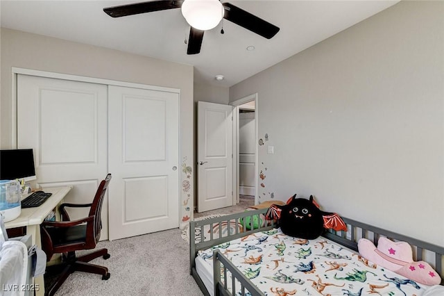 bedroom with a closet, light carpet, and a ceiling fan