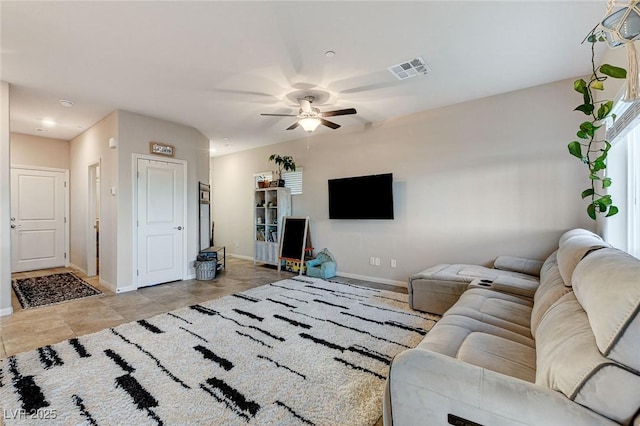 living area with visible vents, baseboards, and a ceiling fan