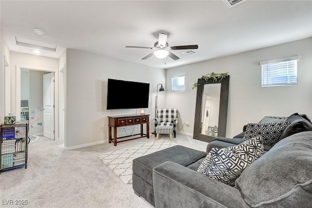 living area featuring visible vents, baseboards, carpet, and ceiling fan