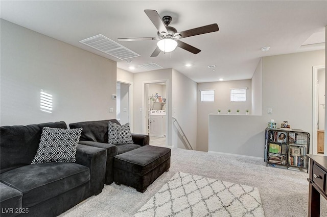 living area featuring visible vents, a ceiling fan, washer / clothes dryer, carpet flooring, and baseboards