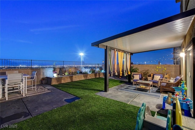 view of yard featuring an outdoor living space with a fire pit, a patio, and a fenced backyard