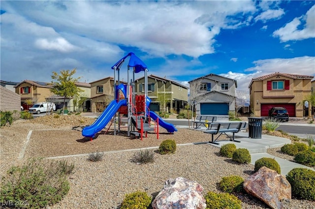 communal playground featuring a residential view