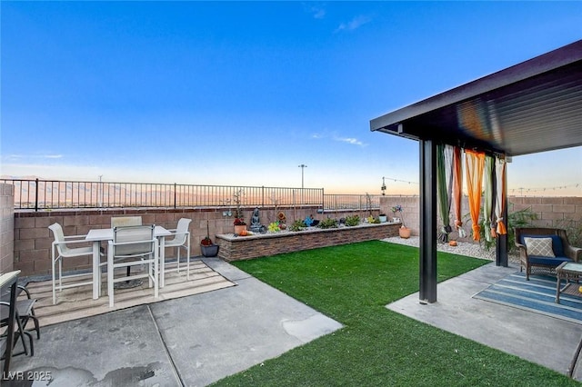 view of yard with outdoor dining space, a patio area, and a fenced backyard