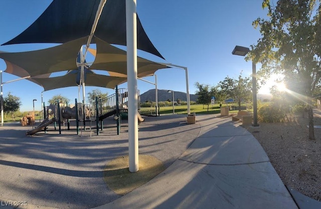 view of community featuring playground community and a mountain view